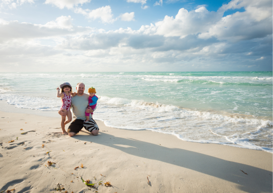 Dad on the beach with kids Dad on the beach with kids